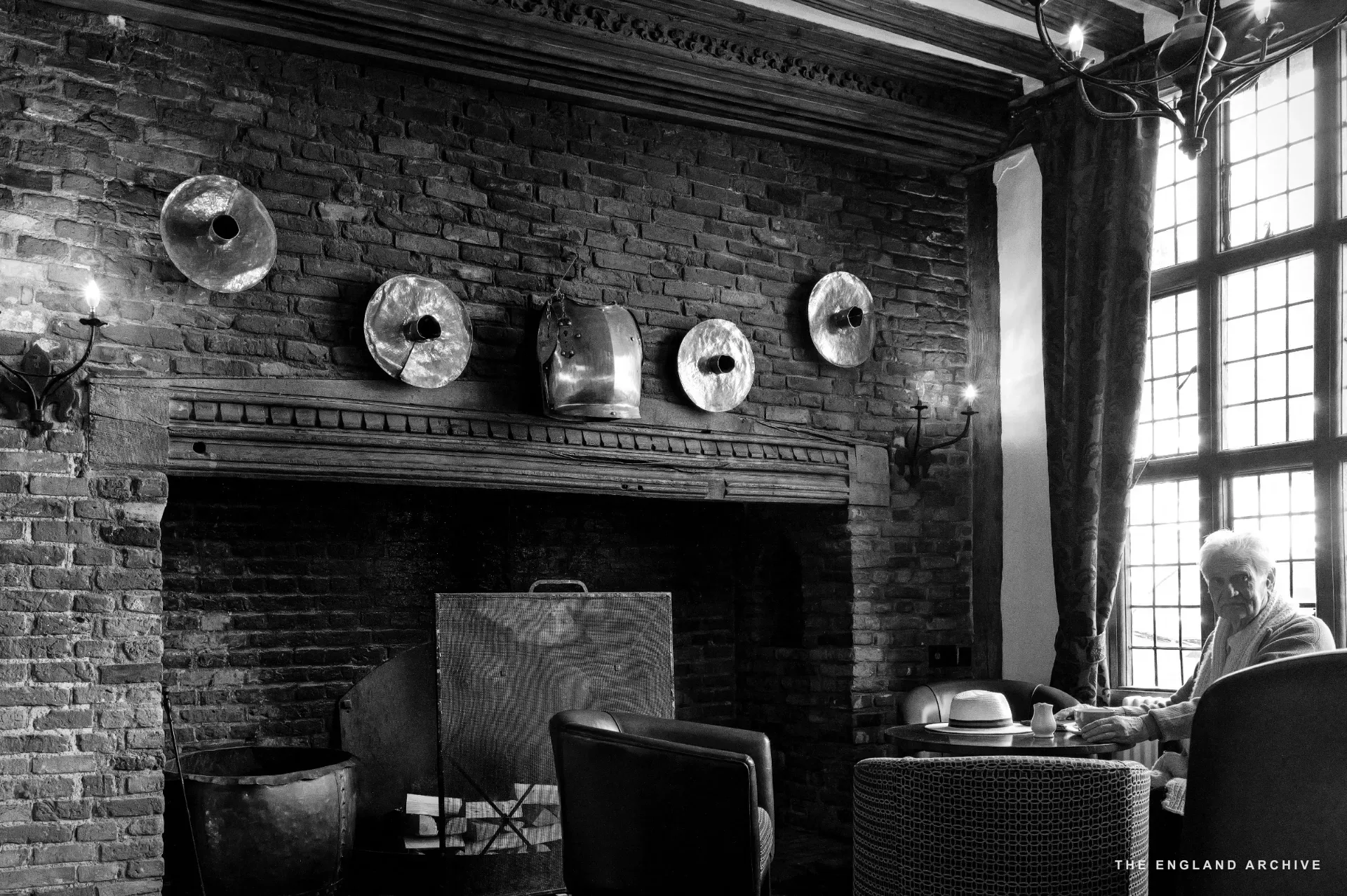 A detail of the carved stone entrance surround at the Bull Hotel, Tudor beams overhead.