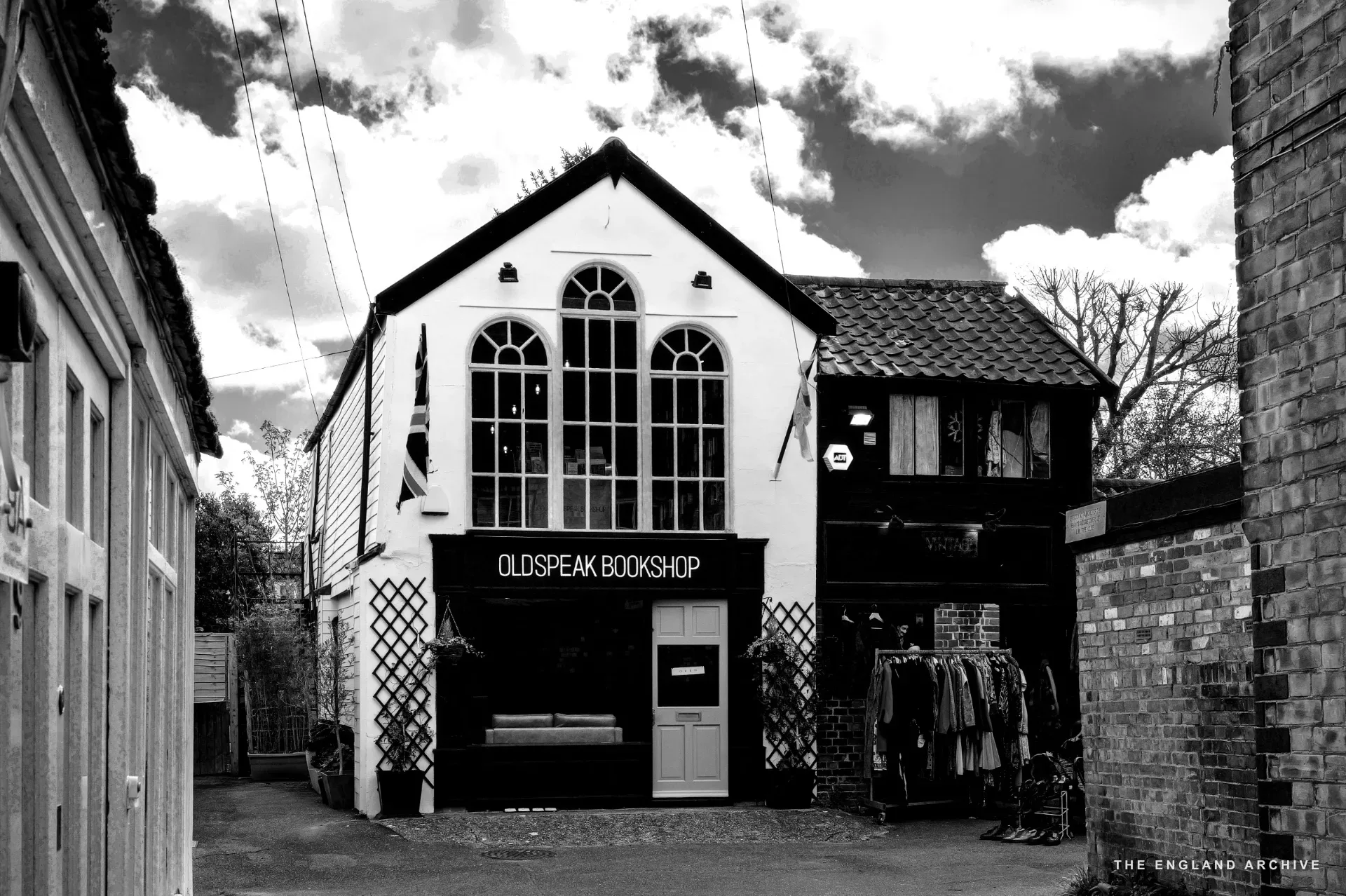 A three-storey Georgian red-brick townhouse above a modern shopfront on Hall Street.