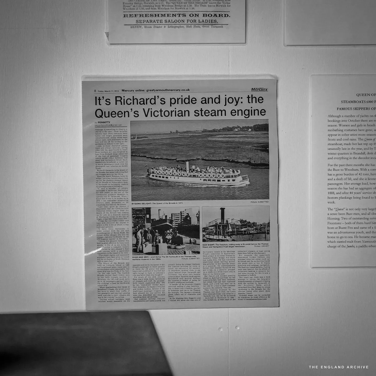 A framed Yarmouth Mercury newspaper clipping pinned to the wall, headlined It’s Richard’s pride and joy: the Queen’s Victorian steam engine, with a photograph of the Queen of the Broads paddle-steamer in operation.