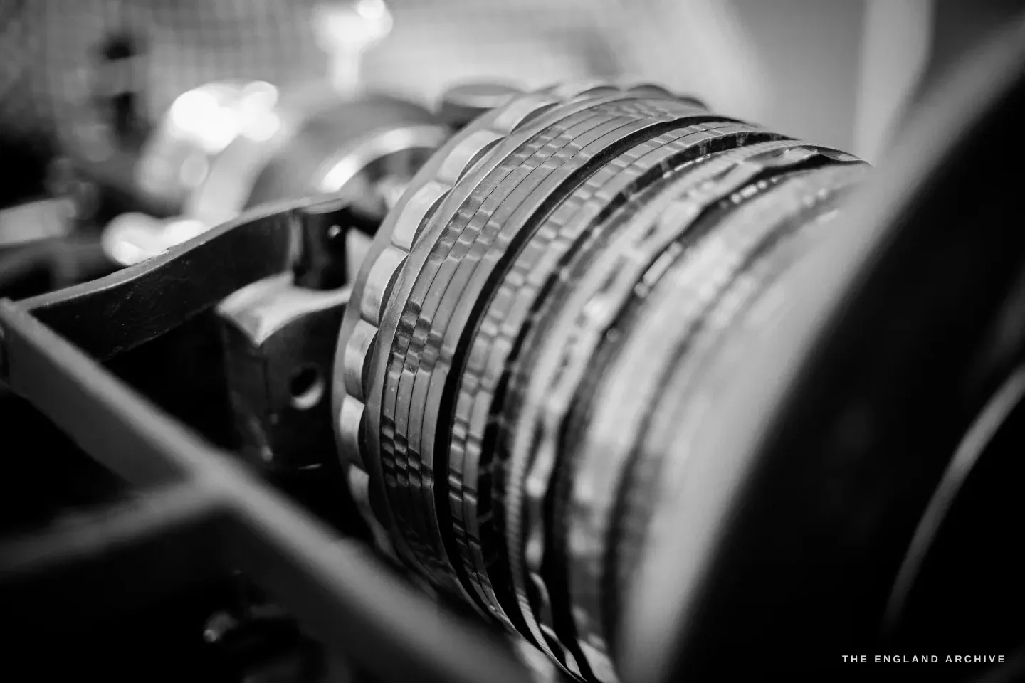 A close-up of the rose engine’s stacked rosettes - patterned cams - seen end-on, framed by the machine’s black cast frame.