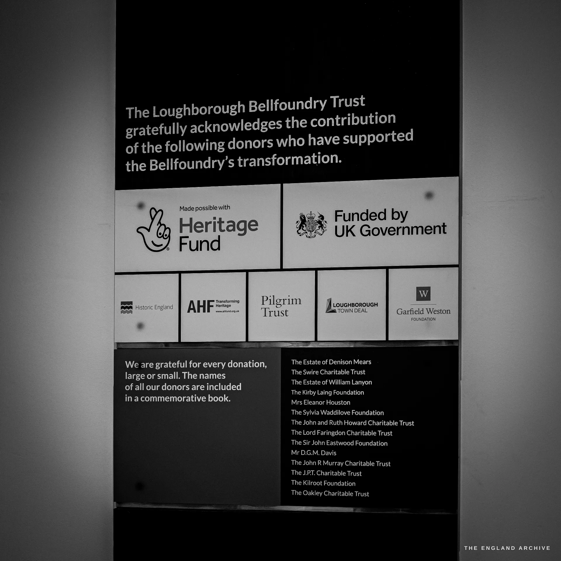 A backlit donor acknowledgement board listing the trusts and funders of the bellfoundry restoration, with their logos.