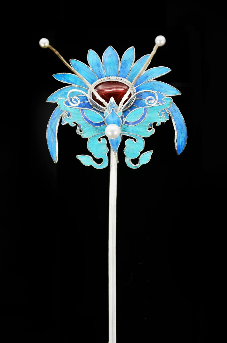 A detail of the chrysanthemum and butterfly hairpin, the feather inlay and wirework close up.