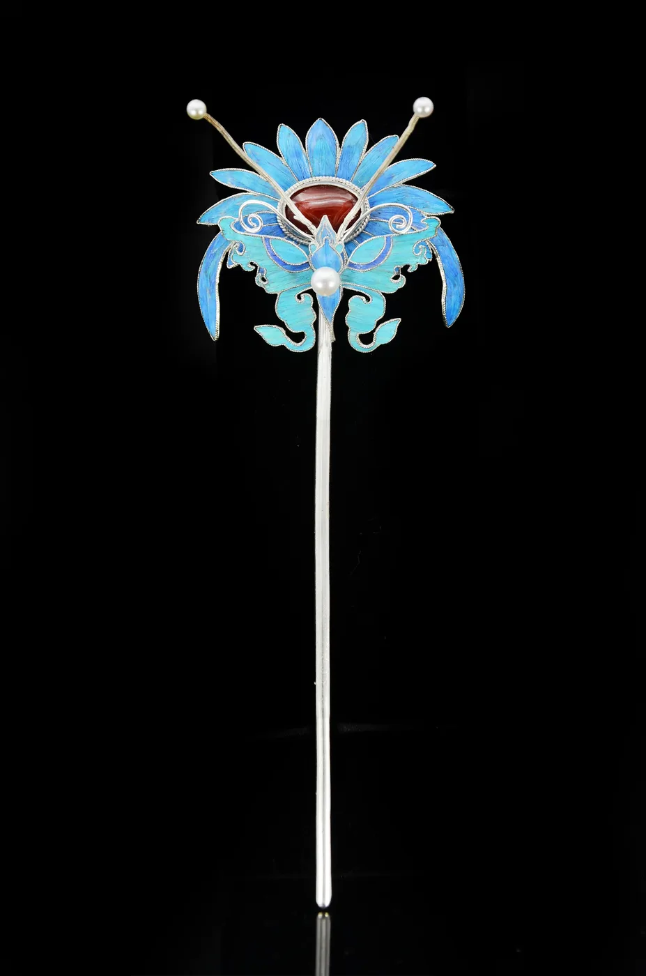 A chrysanthemum and butterfly hairpin in filigree and blue feather inlay.