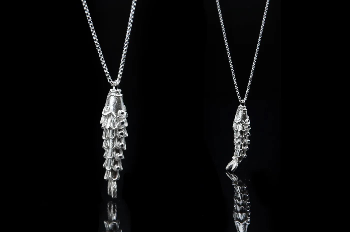 A second view of the articulated filigree fish, showing the jointed scales of wirework.