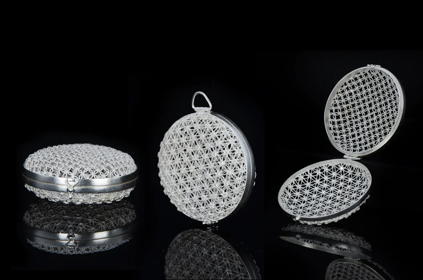 A filigree silver box for a sachet or tea bag, its walls a lattice of fine silver wirework.
