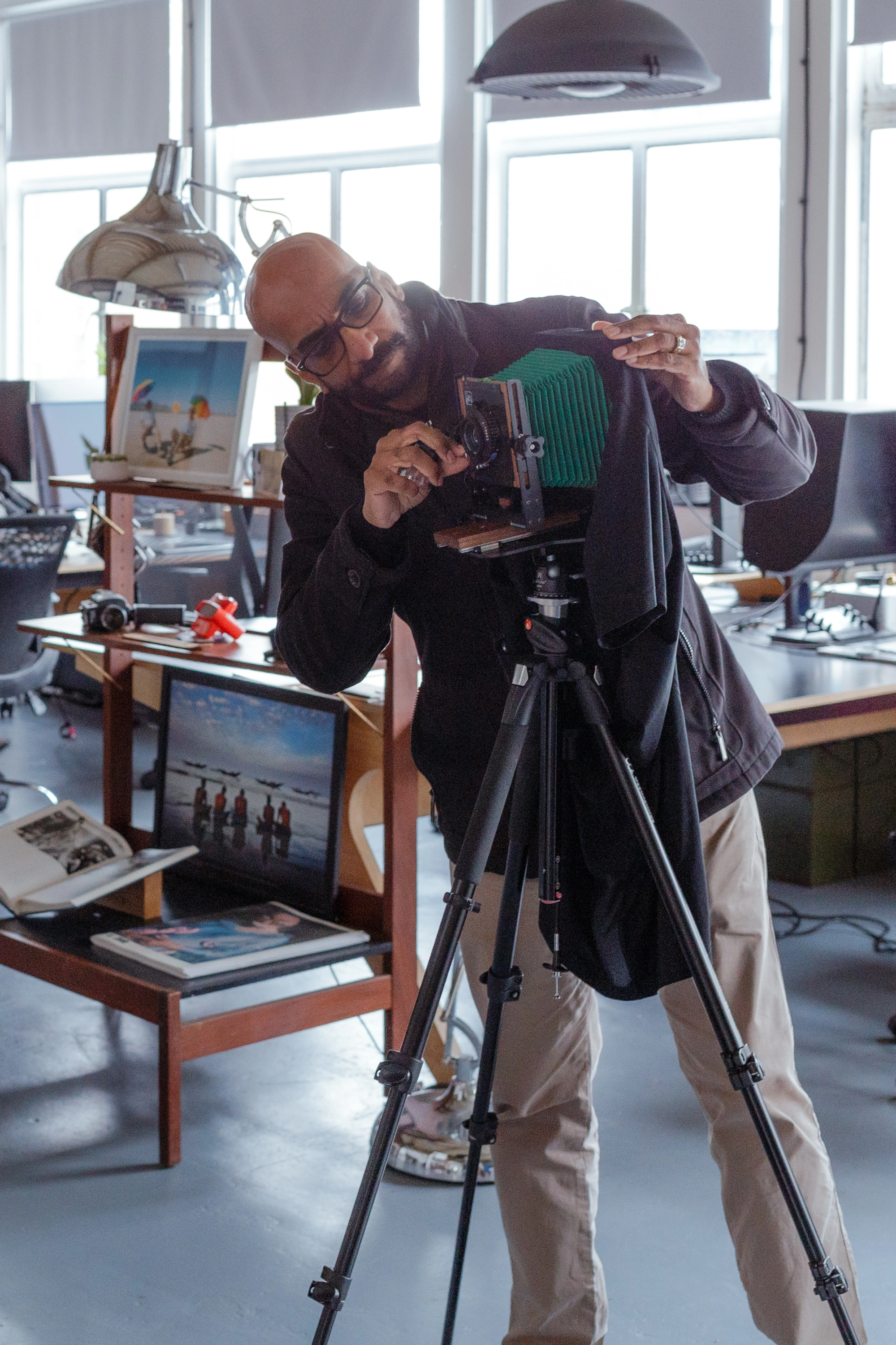 Looking through and adjusting the large format camera from the side - the deliberate process of composing a portrait